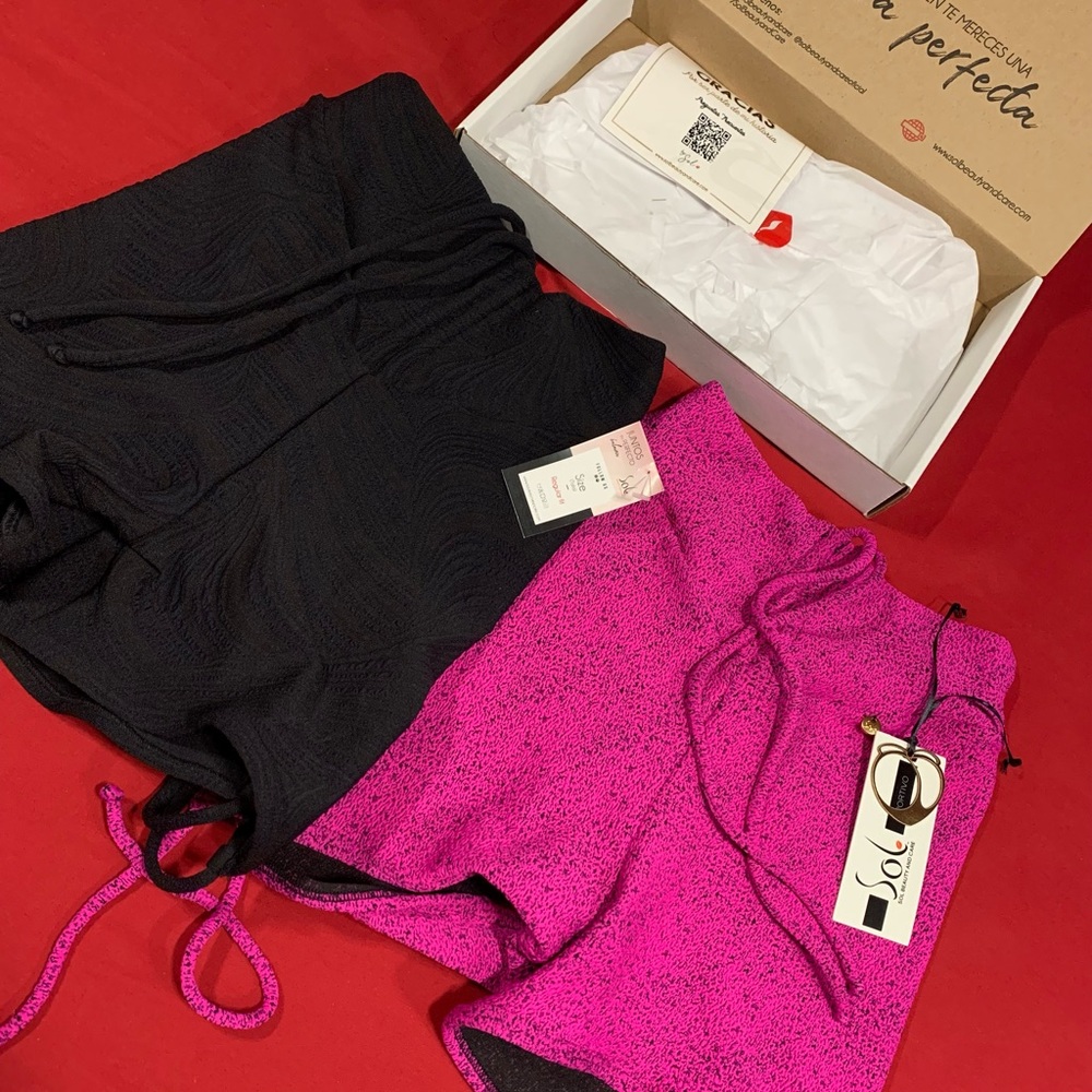 Black and pink scrunched shorts that helps with tummy control